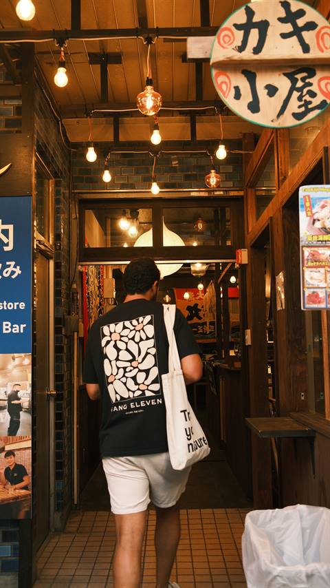 Ze entering an izakaya alley in Tokyo at night