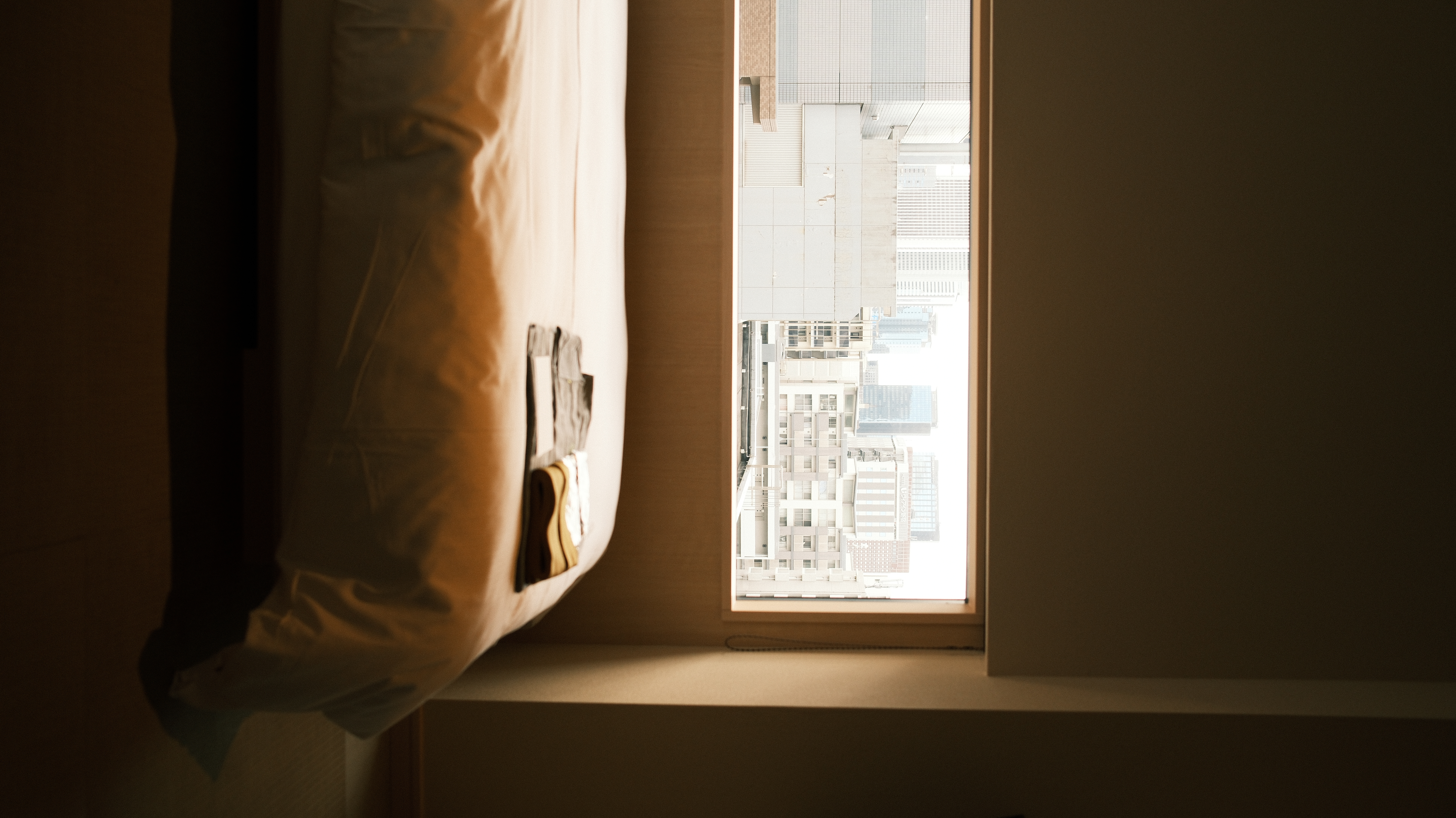 Tokyo hotel room with window view, morning light