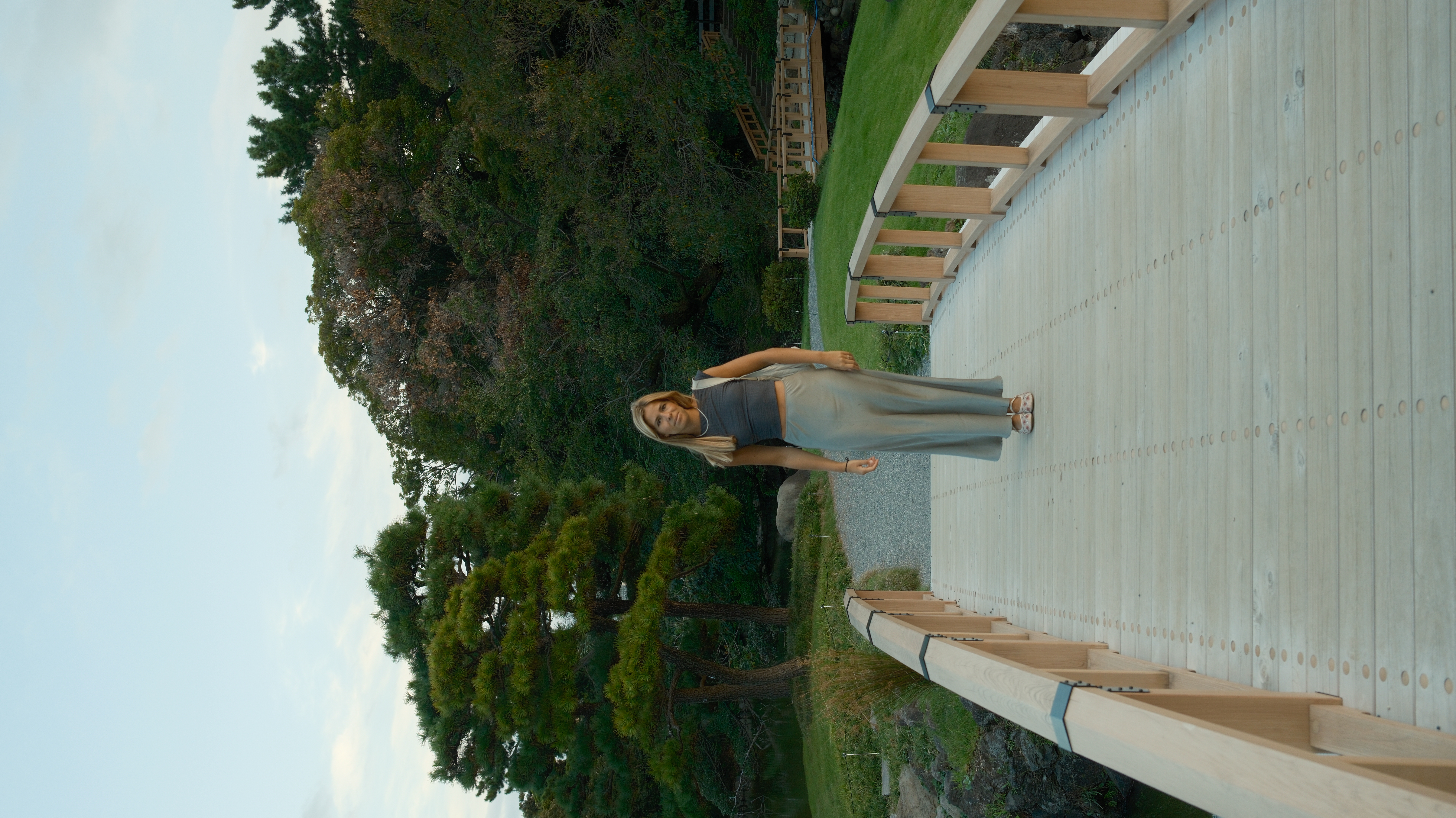 Maria walking along a white elevated walkway in Tokyo