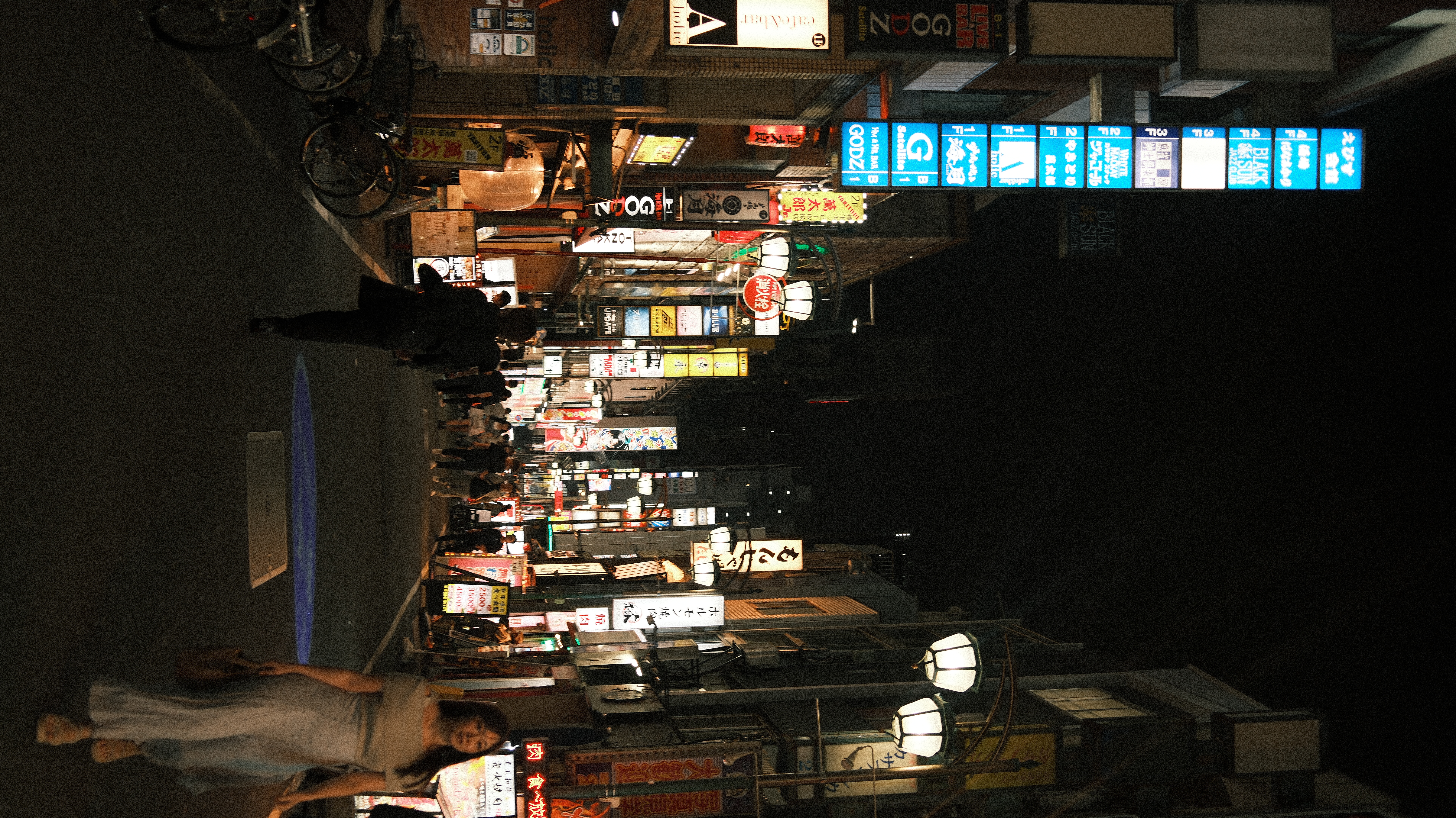 Maria on a neon-lit Shinjuku street at night
