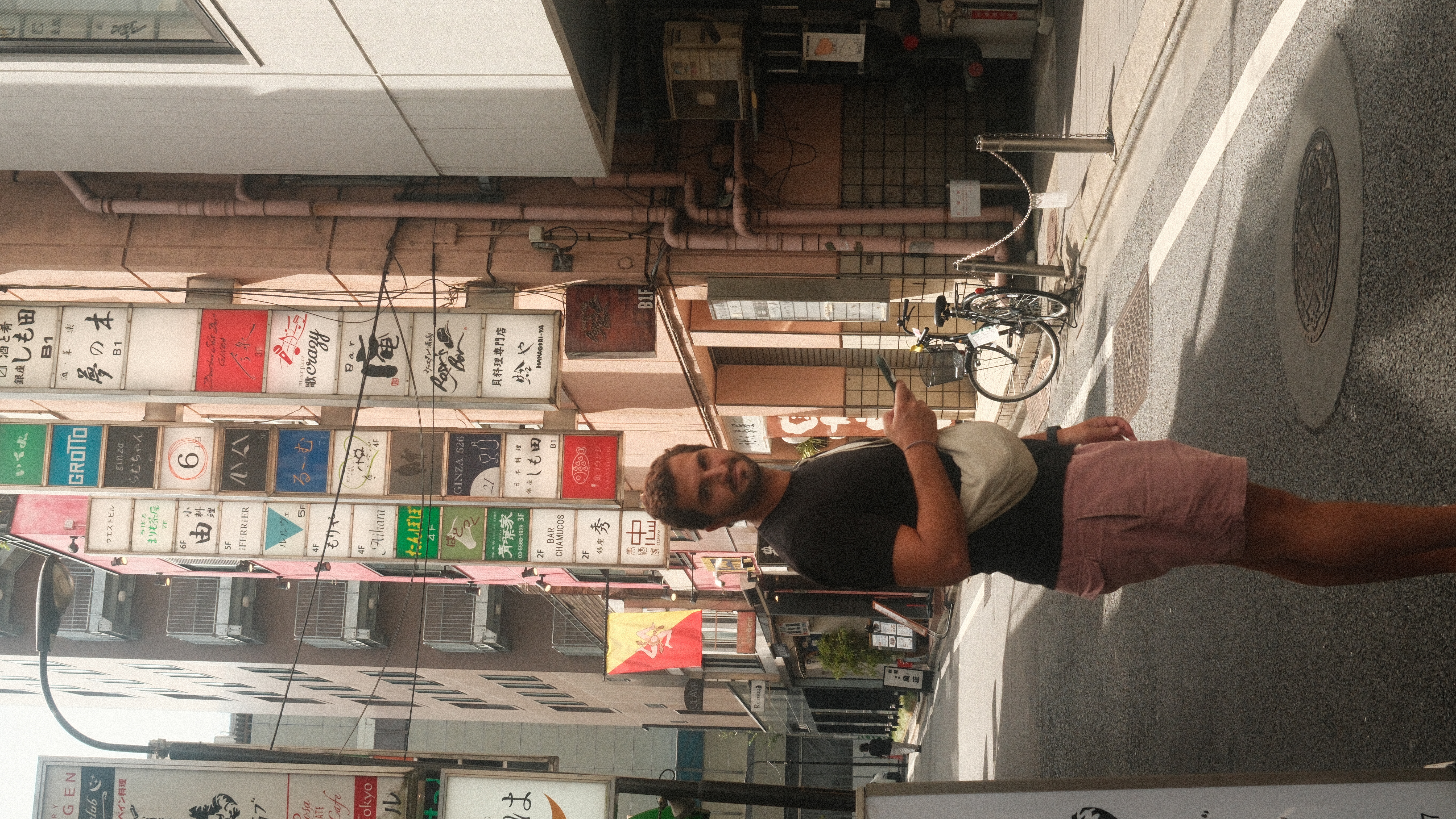 Zé on a busy Tokyo shopping street with Japanese signs