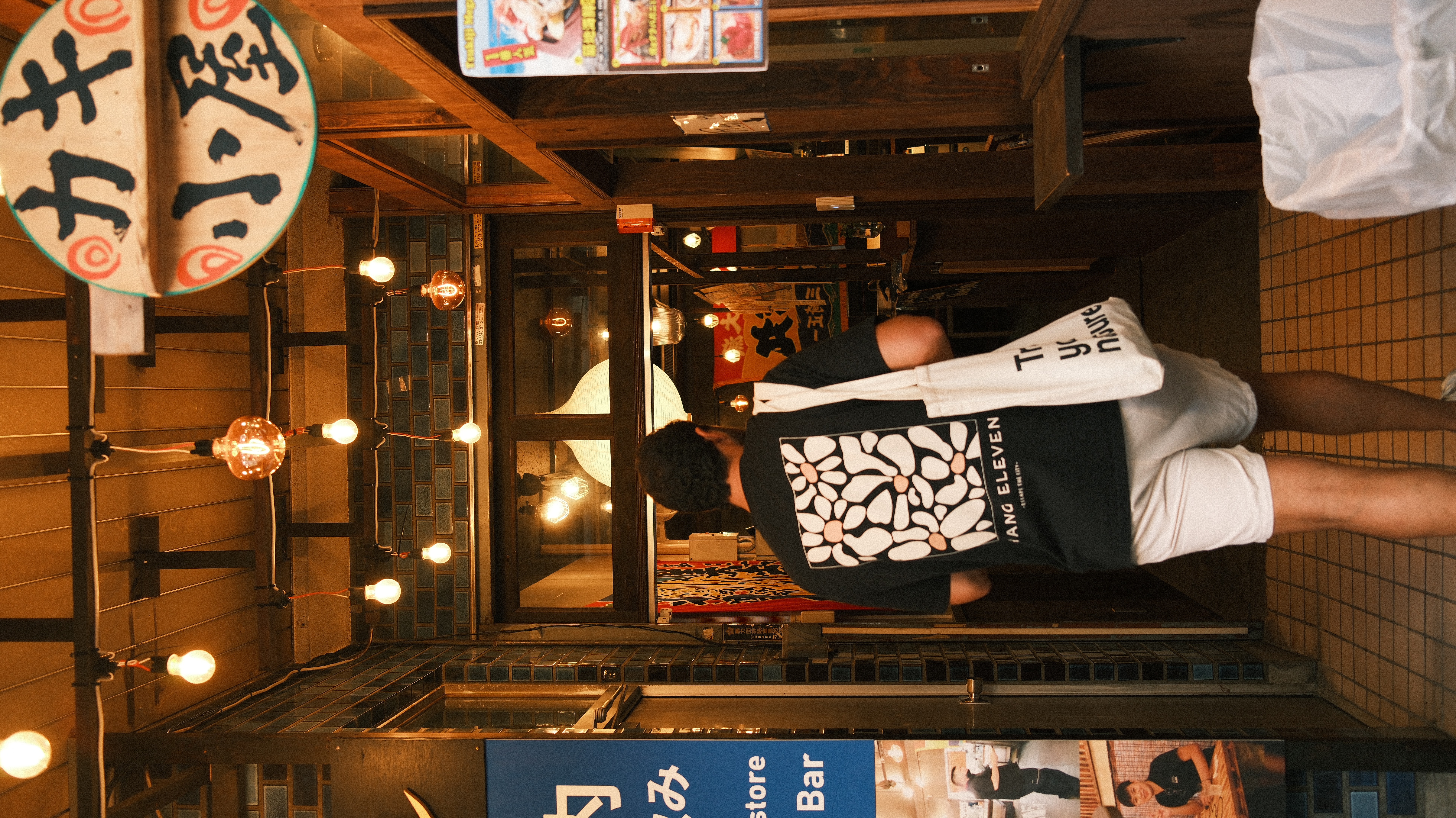 Ze entering an izakaya alley in Tokyo at night