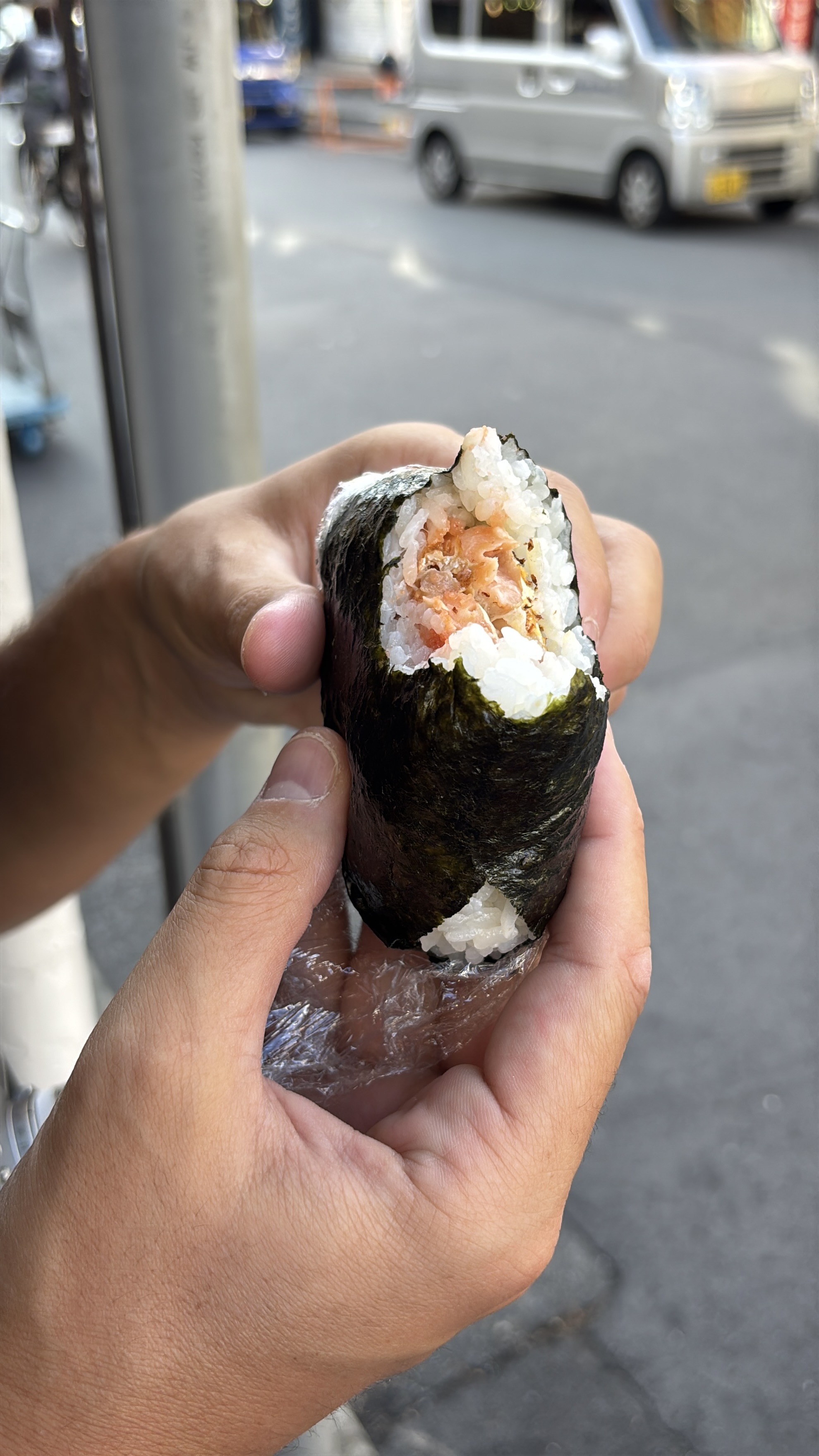 Eating fresh onigiri on the street at Tsukiji market