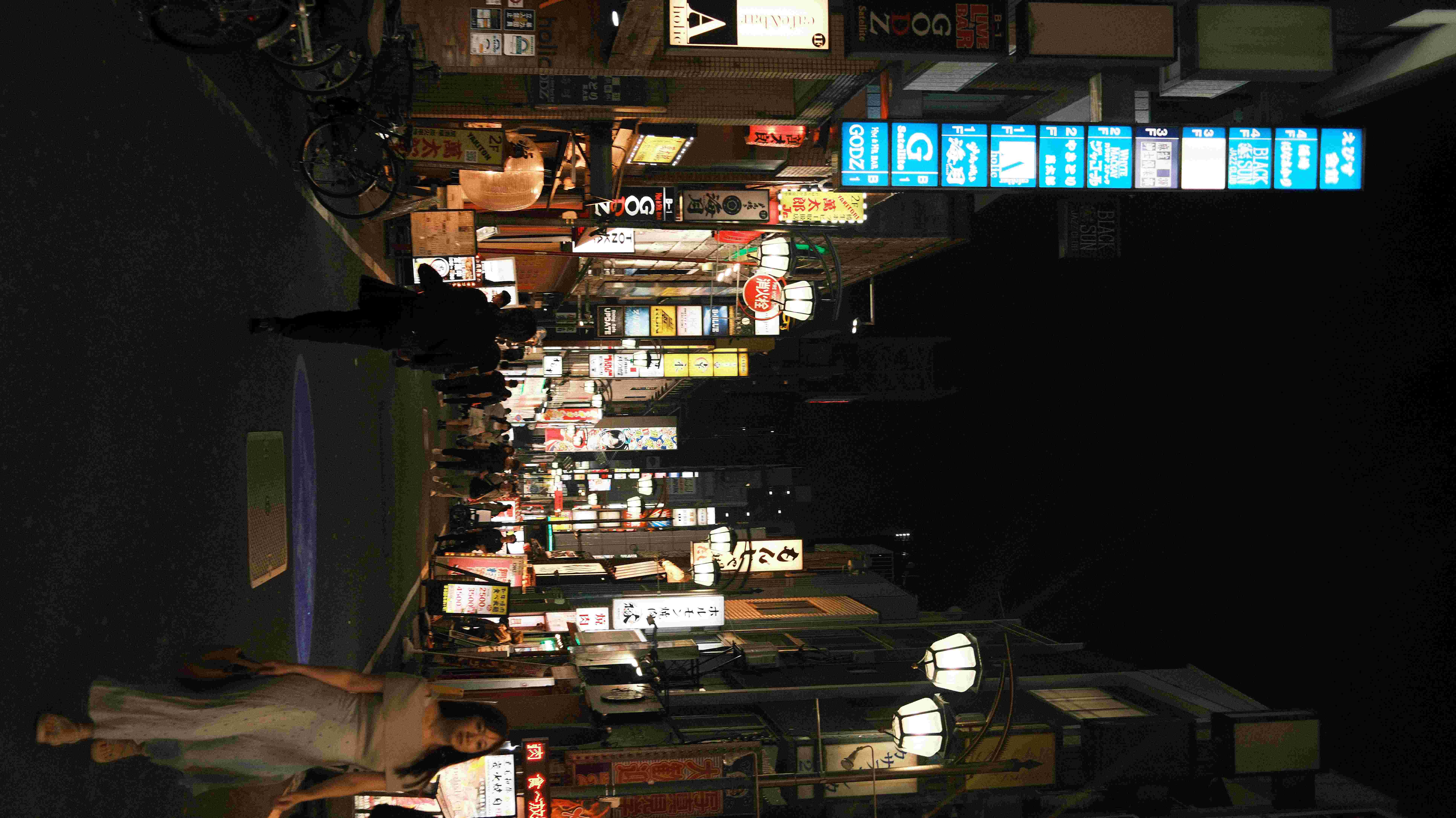 Golden Gai alley at night with illuminated signs, Shinjuku Tokyo