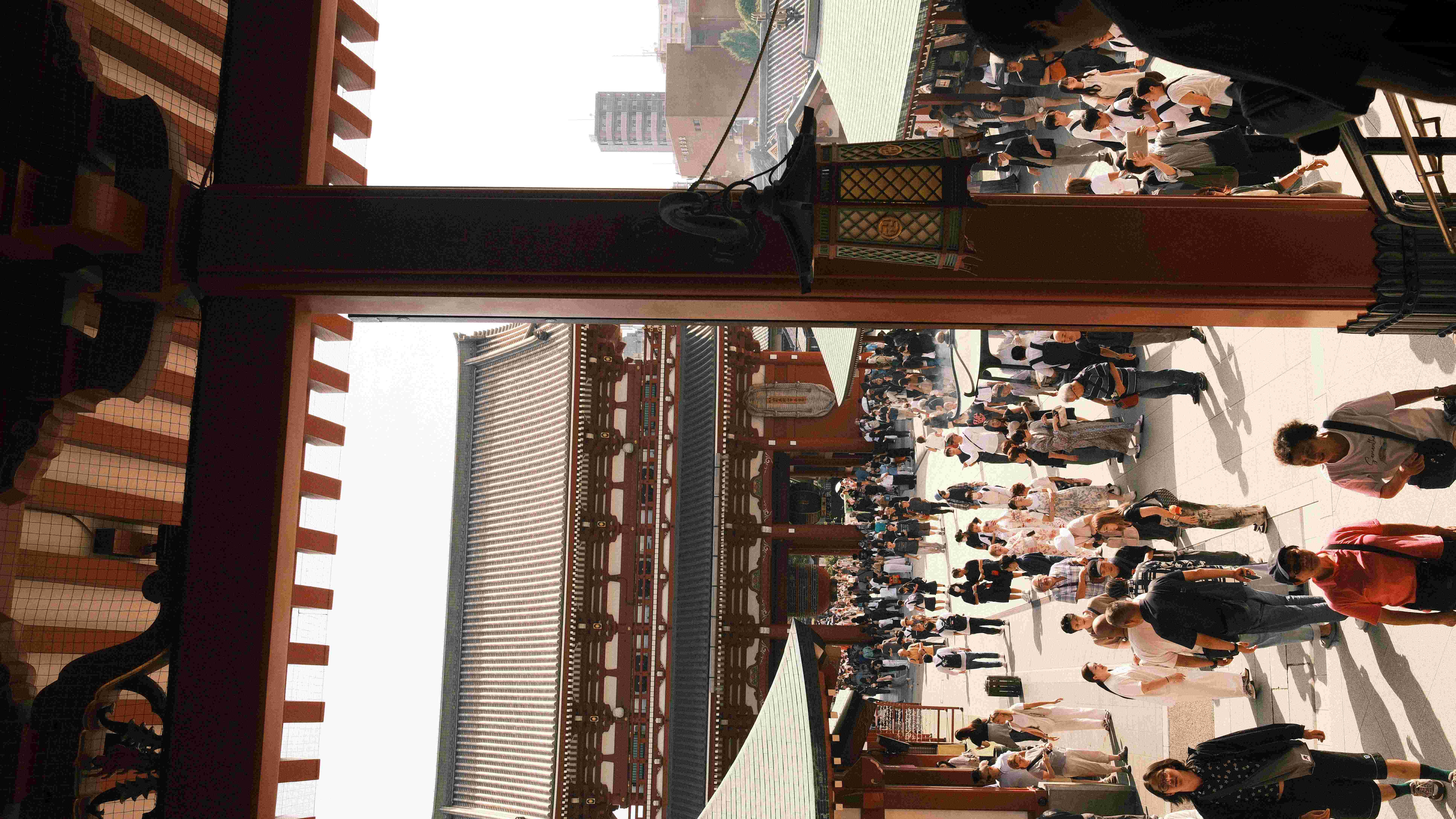 Crowds walking under the lanterns on Nakamise Shopping Street, Asakusa