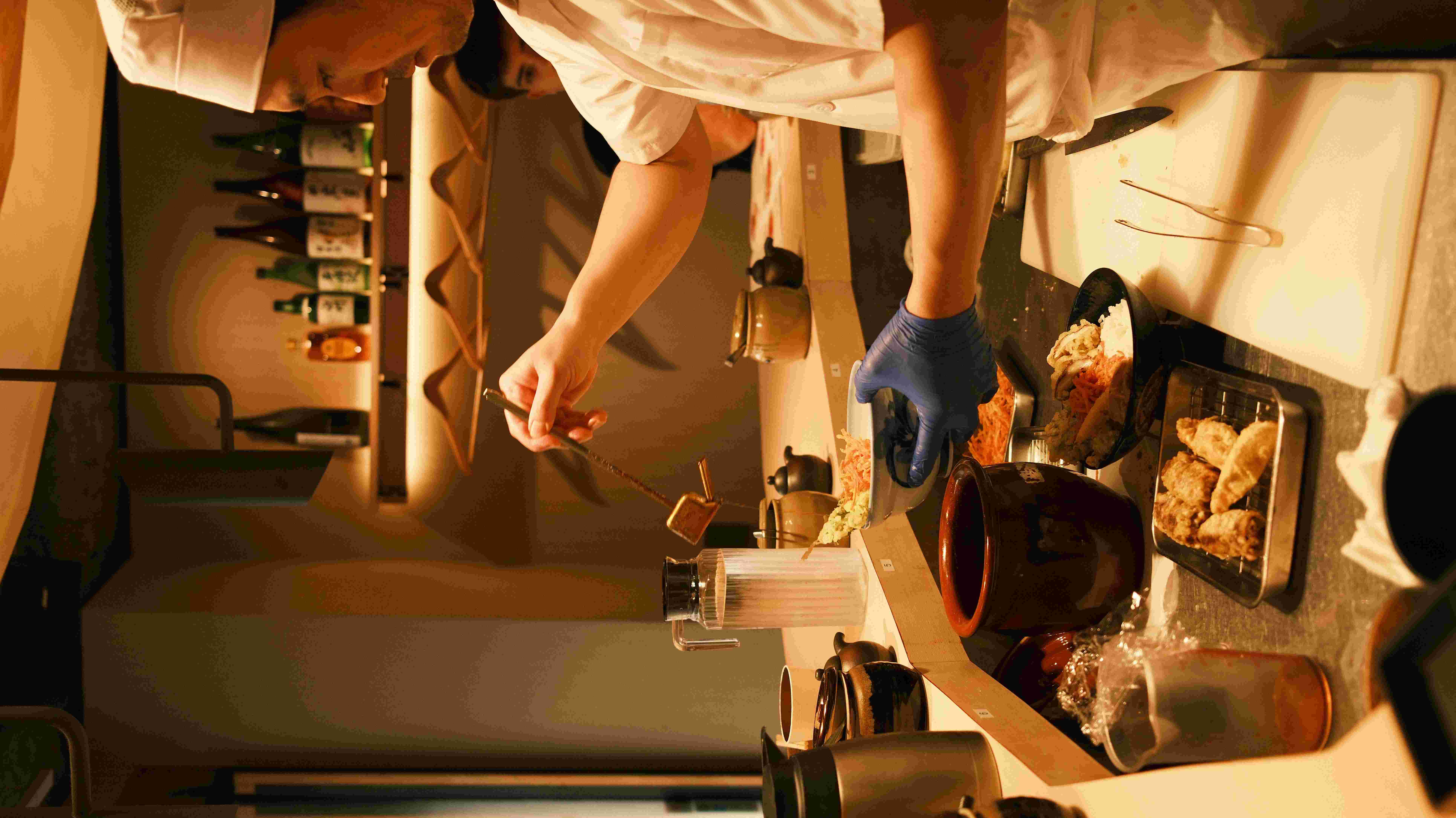 Chef preparing tempura at a Tokyo restaurant counter